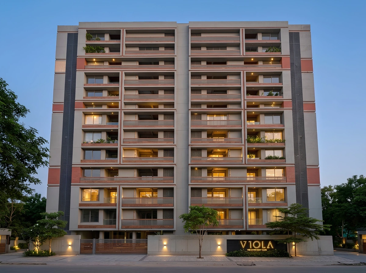 Viola's complete residential façade at dusk, with terracotta balcony detailing, landscaping, and its illuminated name sign.